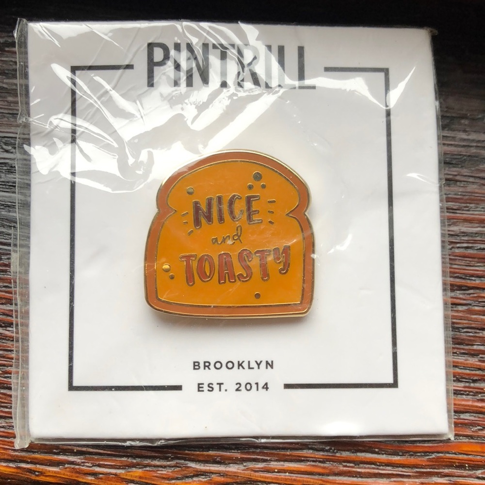 Pintrill Nice and Toasty pin, about 1/2” square.